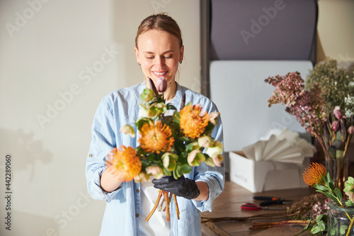 Young woman admiring a beautiful floral arrangement