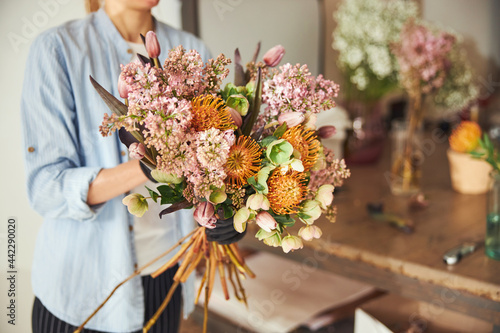 Professional female florist making a beautiful spring bouquet