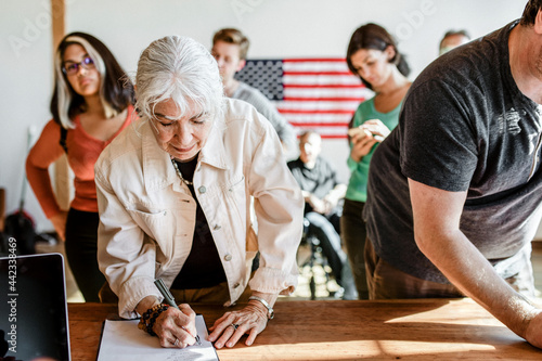 Diverse people queuing at a polling place