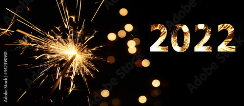 2022 in burning sparkler flames. Silvester background banner panorama sparkling lights firework. Abstract Sparklers for celebration. Magic light. Happy new year and Merry Christmas concept.
