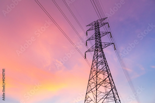Horizontal silhouette of electric pole with purple blue sky in the evening.