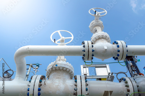 Oil and gas processing plant with pipe line valves.Industrial zone, Steel pipelines and valves blue sky.Oil pipeline valves in the oil and gas industry.