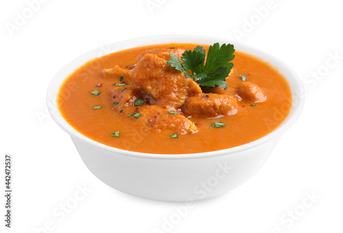 Bowl of delicious chicken curry on white background