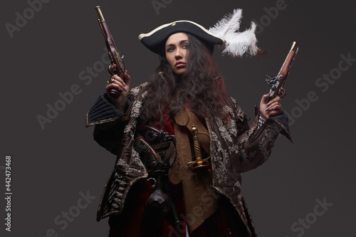 Brunette caribbean corsair with dual flintlock guns