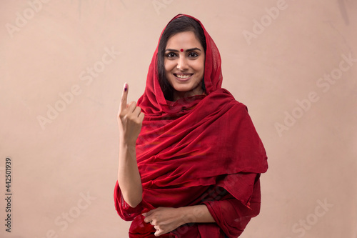 Portrait of a woman standing with voters mark.