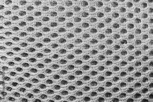 Close-up texture photo of grey colored spacer mesh material pattern.