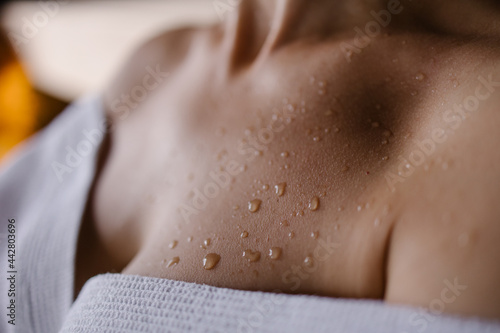 Close-up of a sweat drop in the sauna. Close-up skin after shower. Tanned body. Detox program in the spa concept. hot to sweat Lifestyle Aesthetically