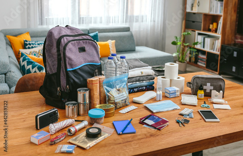 Emergency backpack equipment organized on the table in the living room