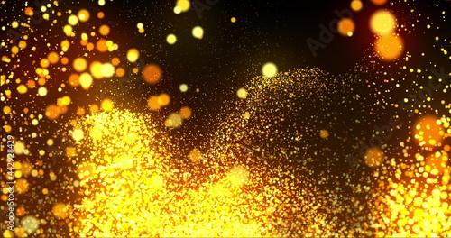 A mass of golden glowing particles effervescing on black background