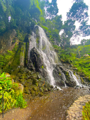 Beautiful waterfall surrounded by a green landscape in Sao Miguel, Azores.