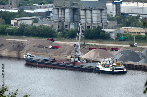 Barge on the river Unloading river sand from a barge Navigable river, river port. High quality photo