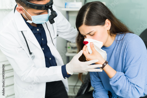 Sick young woman bleeding from the nose