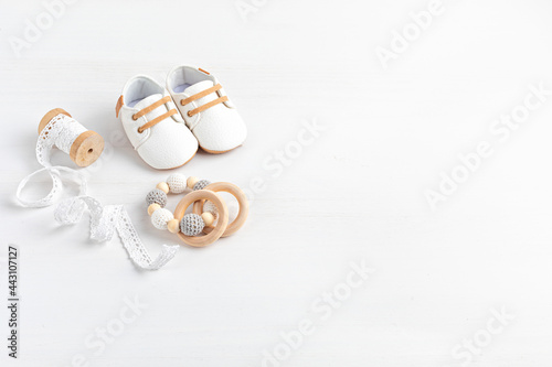 Gender neutral baby shoes and accessories. Organic newborn fashion, branding, small business idea. Baby shower, baptism invitation, greeting card. Flat lay, top view