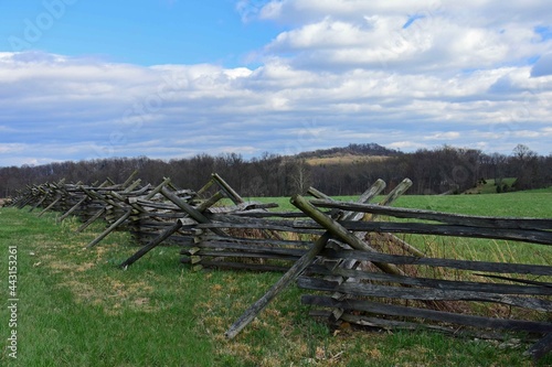 wooden fence , field, and big round top mountain near cemetery ridge in the historical gettysburg battlefield, pennsylvania