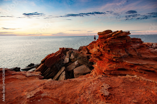 A distant figure looks out across the ocean at Gantheaume Point, Broome.