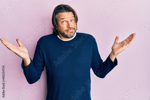 Middle age handsome man wearing casual clothes clueless and confused with open arms, no idea and doubtful face.