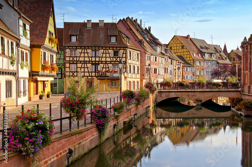 Colmar, France, late day view with half timbered houses, flowers, bridge and reflections in the beautiful canals