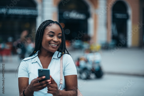 African american woman using a smartphone while touring the city