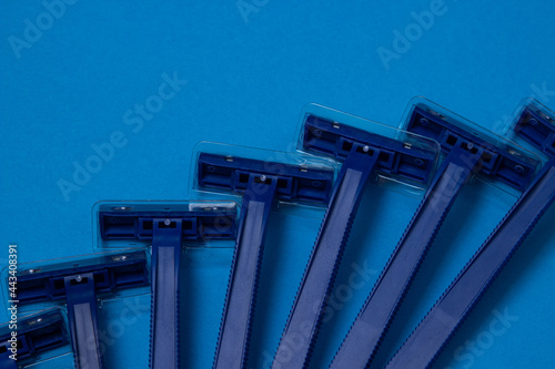 Men's razors on a blue background. Disposable men's razor close-up.