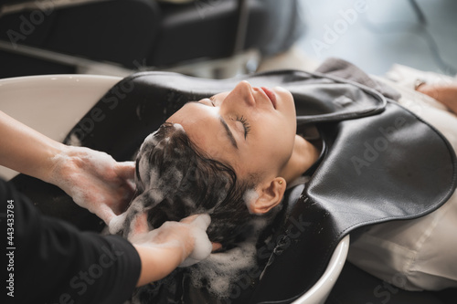 hairdresser washing client's hair at salon. happy young women customer relax and comfortable while washing hair, luxury hair spa by professioner hairstylis
