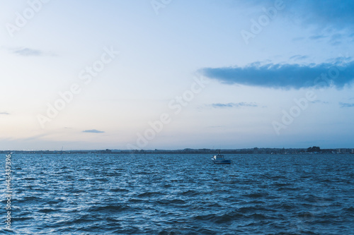 view of a boat on the sea with a sunset