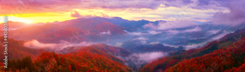 Scenic view of wooded Alps mountains at sunrise, amazing autumn landscape with mountain ridge, colorful trees, morning mist and cloudy sky, Jamnik, Slovenia. Outdoor travel background