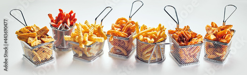 Metal baskets with French fries on white background