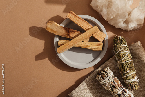 Set of incense for fumigation of premises. Tied in bunch of sprigs of white sage, crystals and sticks of Palo Santo. Top view. Organic holy tree incense from Latin America. Close-up color photo