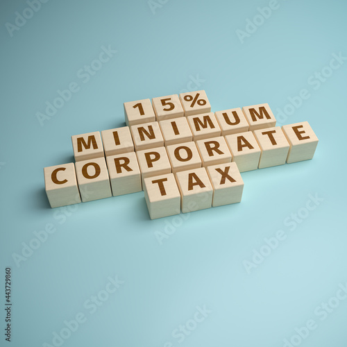 Wooden toy blocks forming the words "15% minimum corporate tax". Initiative to implement a global minimum tax for large companies.