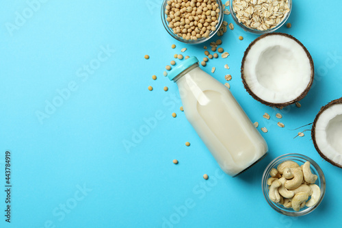 Concept of vegan milk on blue background, top view