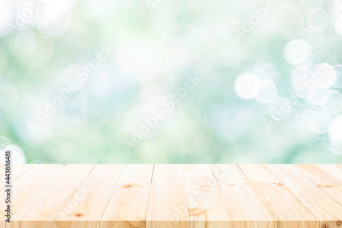 empty wooden table on green bokeh background