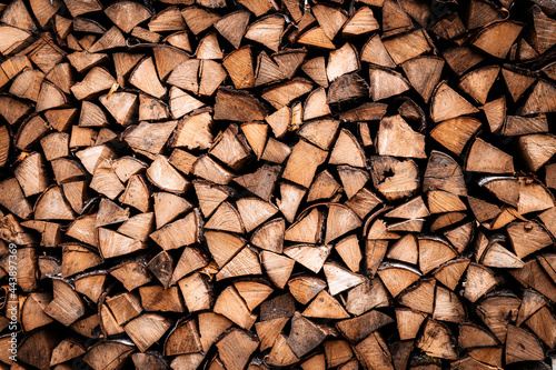 textured firewood background of chopped wood for kindling and heating the house. a woodpile with stacked firewood. the texture of the birch tree