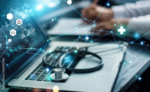.Healthcare business graph data and growth, Insurance Healthcare. Doctor analyzing medical of business report and medical examination with network connection on laptop screen.
