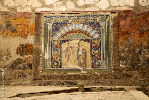 A Roman mosaic on a wall in the House of Neptune and Amphitrite. Ruins of ancient roman town Ercolano - Herculaneum, destroyed by the eruption of the Mount Vesuvius, Vesuvio volcano. Italy