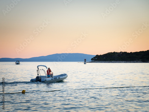 Man on a motorboat talking on his mobile phone