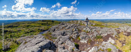 A giant panorama, a view from above on the taiga expanse from the rocky top of Kivakka, Paanayarvi National Park. Karelia. Warship Cross on a mountain top, Rock structure. Climbing. . Karelia