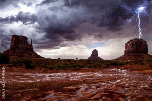 Lighting strikes a large butte during a heavy thunderstorm in Monument Valley, Arizona.