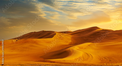 Golden Sand Dune Desert Landscape Panaroma. Beautiful sunset over the sand dunes in the Al Madam Desert, Sharjah, UAE.