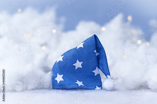 Blue nightcap with stars surrounded by clouds and stars