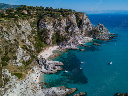 Aerial view of Capo Vaticano, Calabria, Italy. Lighthouse and promontory. Rocks overlooking the sea. Praia I Focu beach and A Ficara beach. Boats and bathers and crystal clear sea. Costa degli Dei