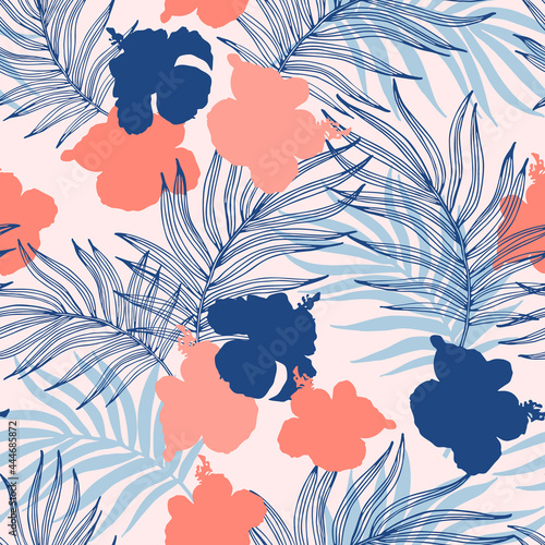 Beautiful hibiscus flowers and palm leaves on the pastel colored background