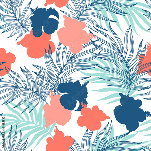 Beautiful hibiscus flowers and palm leaves on the pastel colored background