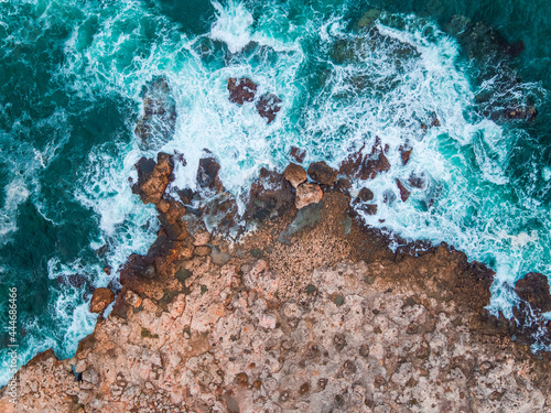 Aerial view of rocky coastline and crashing waves