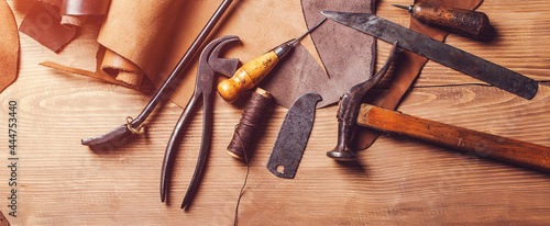 Leather craft workshop. Shoemaker's work desk. Tools and leather at cobbler workplace.