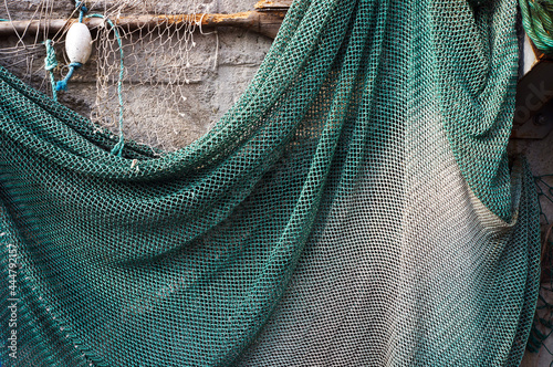 Fishing net hanging on a wall for drying.