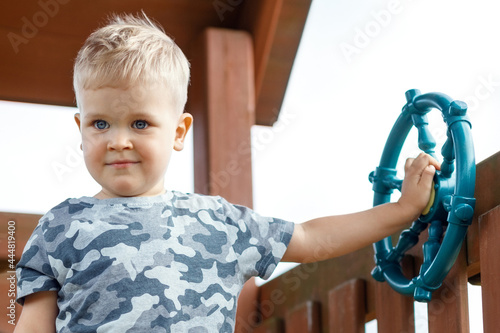 Little boy driving ship in a playground
