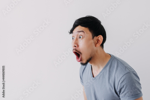 Shocked and surprised face of Asian man in isolated on white background.