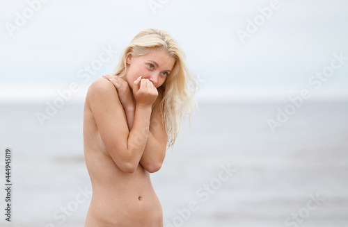 Portrait of a young naked woman on nature background