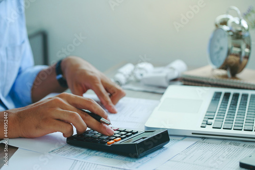 Man doing finances and calculate about cost to real estate investment and in other, tax system.Time for Taxes Money Financial Accounting Taxation Concept