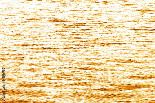 Golden light reflected on the surface of the evening water.